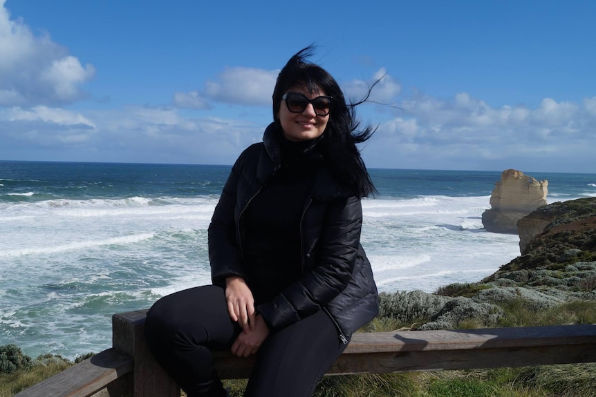 Woman posed for a photo along a coast line.