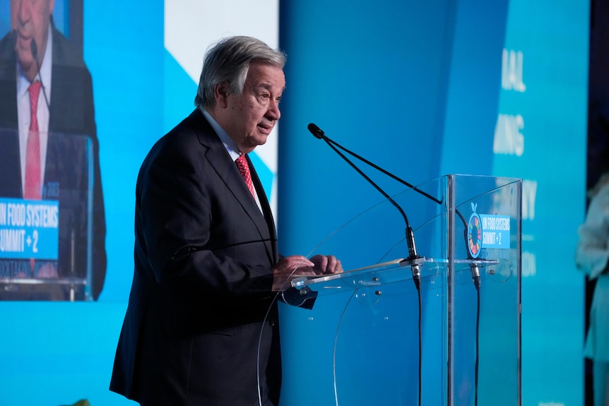 UN Secretary-General Antonio Guterres stands at a lectern delivering a speech