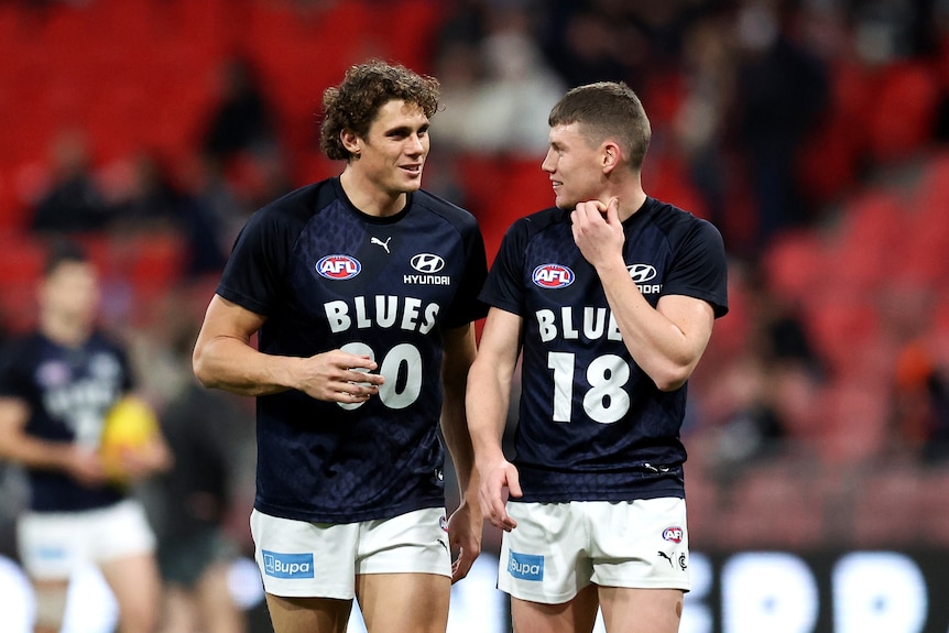 Charlie Curnow and Sam Walsh smile together during warm ups with Carlton