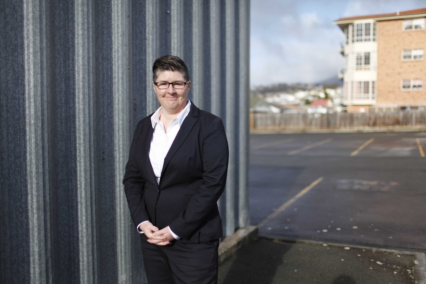 Lucy O'Flaherty, wearing a suit, poses for a photo.