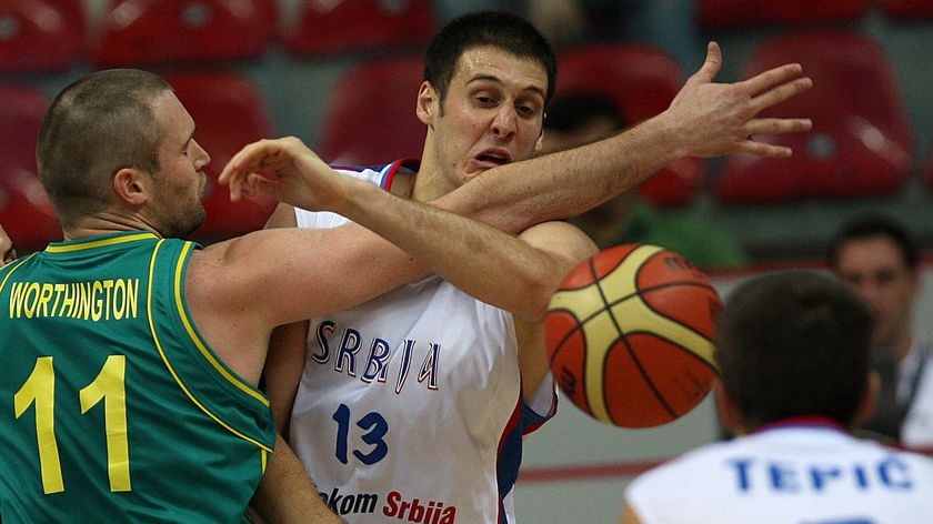 Australia's Mark Worthington tries to halt the Serbian momentum.