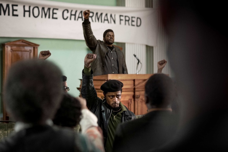 Actors Daniel Kaluuya & Lakeith Stanfield playing Black Panthers, fists raised, in film Judas and the Black Messia