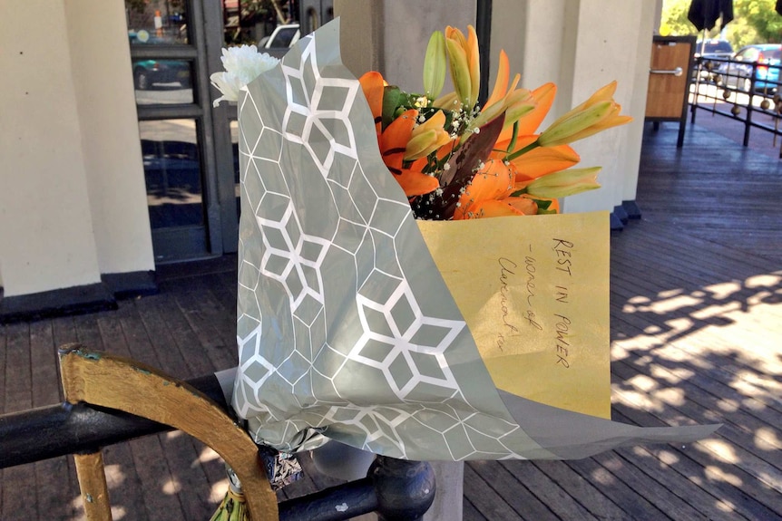 Flowers left outside the Claremont Hotel with a note reading, "Rest in power".