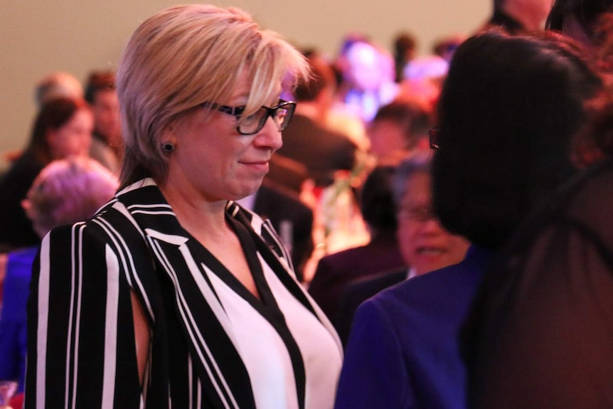Rosie Batty stands among a crowd.