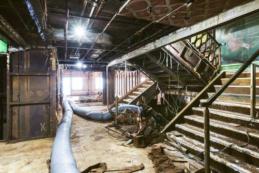 Water-damaged stairwell, with debris strewn everywhere.