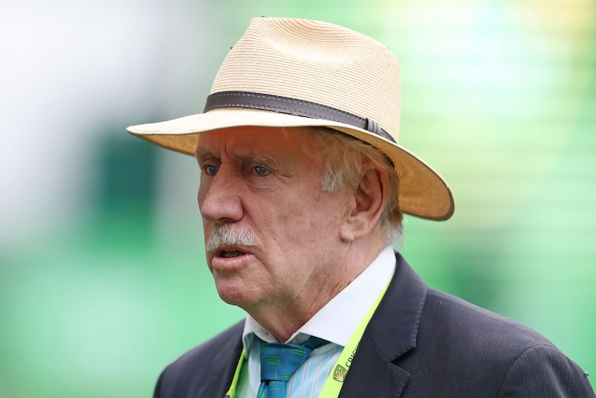Ian Chappell stands wearing a suit and a wide-brimmed hat