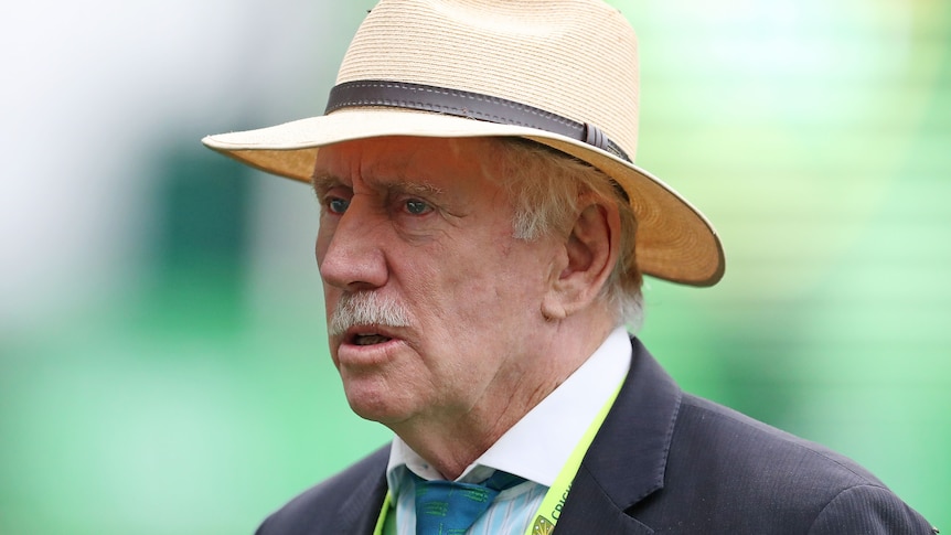 Ian Chappell stands wearing a suit and a wide-brimmed hat