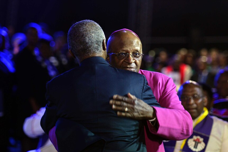 Archbishop Desmond Tutu greets former South African president Thabo Mbeki at Mandela's funeral