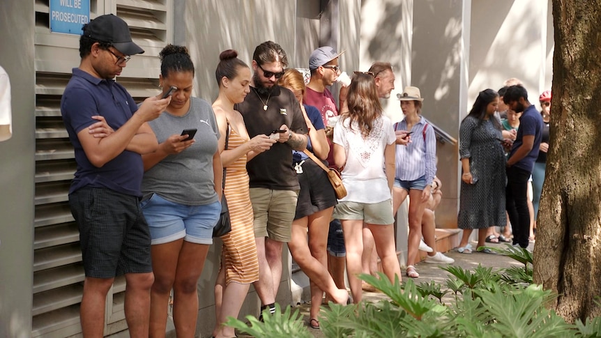 People waiting in line to view a rental property