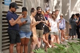 People waiting in line to view a rental property