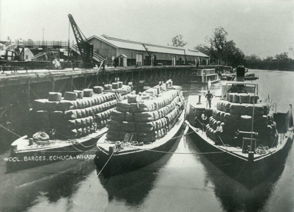 Paddle steamer barges fully loaded with wool packs.