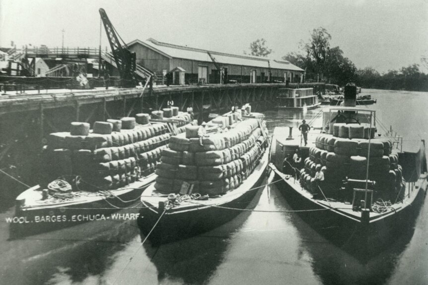 Paddle steamer barges fully loaded with wool packs.
