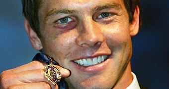 Ben Cousins holds up to 2005 Brownlow Medal.