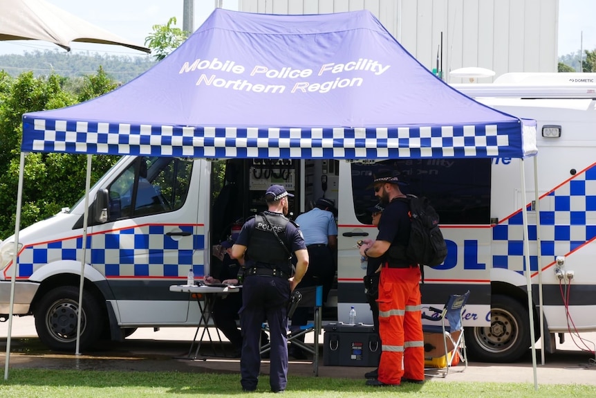 Police and SES in front of a police van