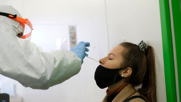 A woman undergoes the rapid antigen test for the coronavirus