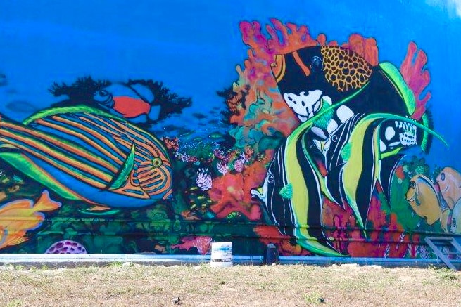 A large sign in Bowen reading 'Bowenwood' has been re-painted with fish and other outdoor elements.