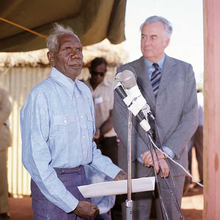 Photo of Vincent Lingiari speaking at the Wave Hill handover beside Gough Whitlam