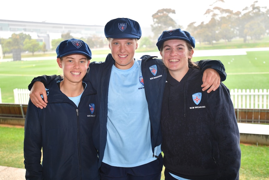 Litchfield, Silver-Holmes and Horley stand together with their arms around each other and their blue NSW caps on 