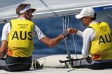 Two Australian sailors congratulate each other during their Tokyo Olympics competition.