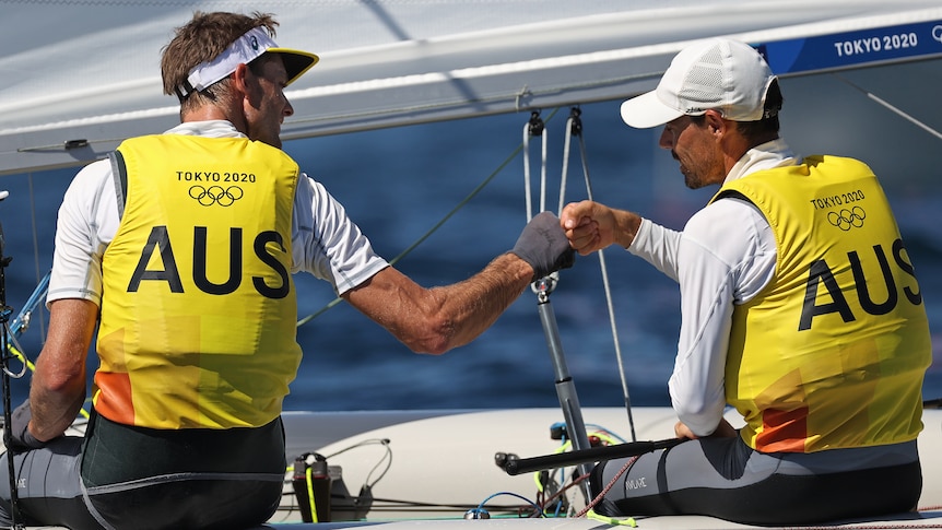 Two Australian sailors congratulate each other during their Tokyo Olympics competition.