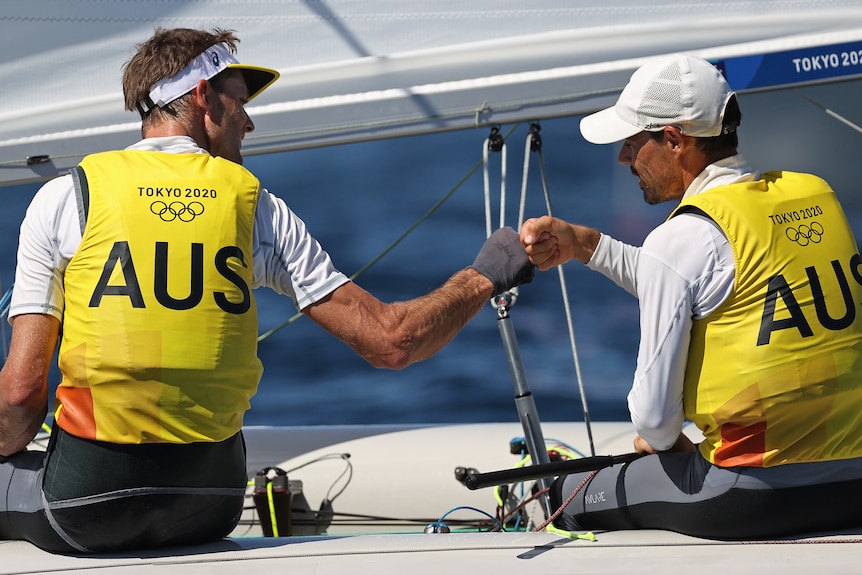 Two Australian sailors congratulate each other during their Tokyo Olympics competition.