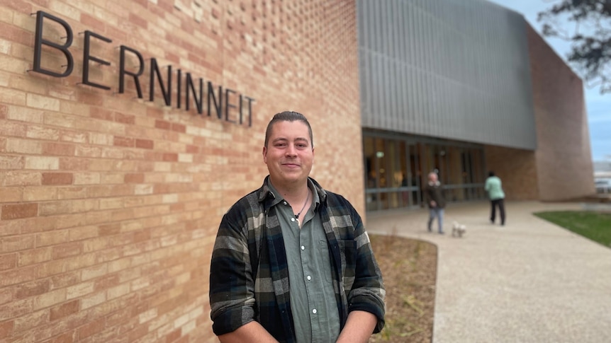 Mitch Mahoney stands in front of Berninneit building  
