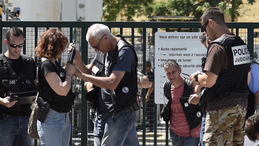 French police secure the entrance of the Air Products company.