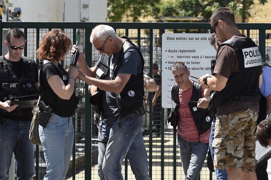 French police secure the entrance of the Air Products company.