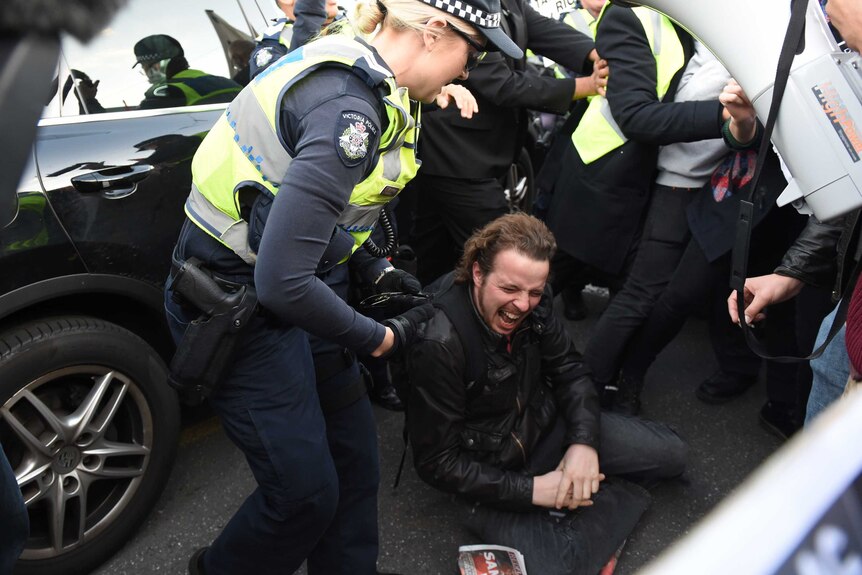 Police clash with students during a protest at the Liberal Party's Victorian State Council dinner