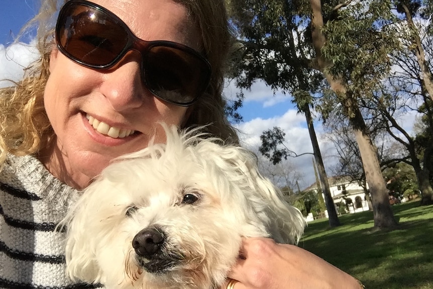 Diane Squires takes a selfie with her fluffy white dog Max