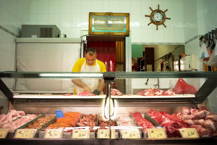 Josef at work in his butcher shop.