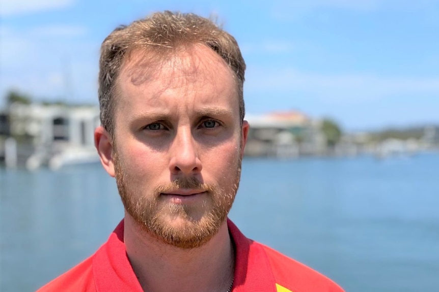 A man wearing a surf life saving queensland shirt