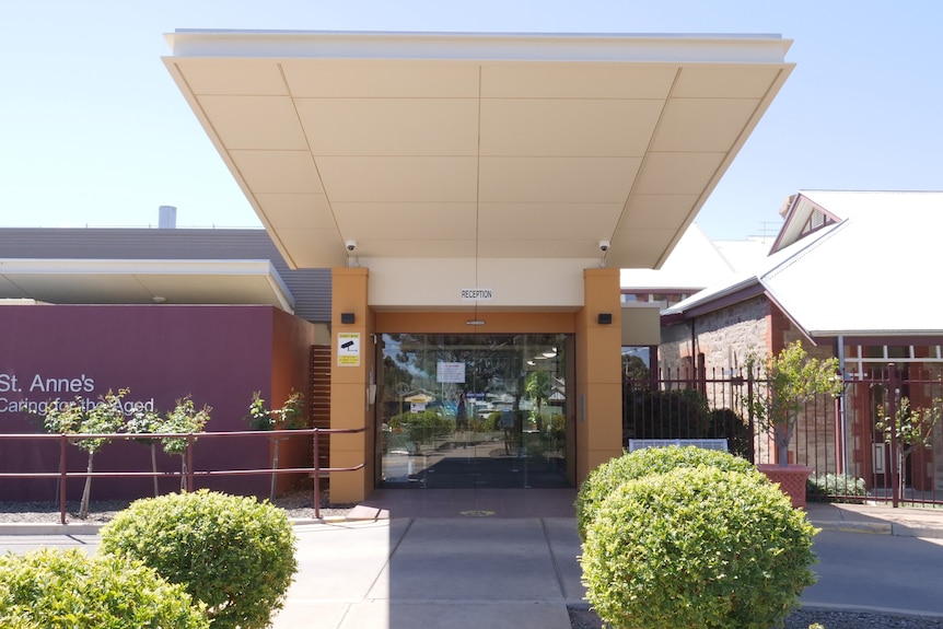 The front of the nursing home, with a path and awning over the driveway.