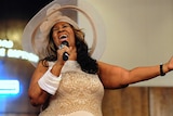 Singer Aretha Franklin sings a song in a church