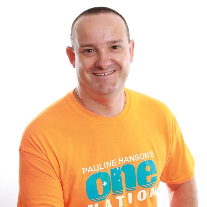 Man in orange t-shirt, smiling