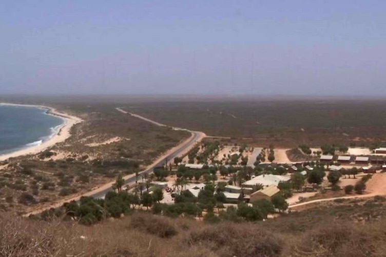 An aerial shot of a holiday park opposite the beach in Exmouth.