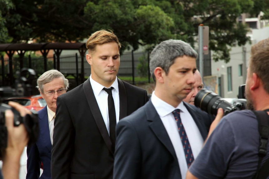 Men in suits walking in a group.