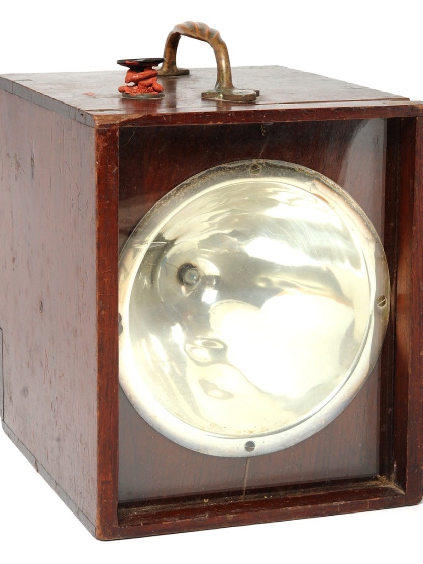 An old morse code signal lamp box, fitted with a small globe.