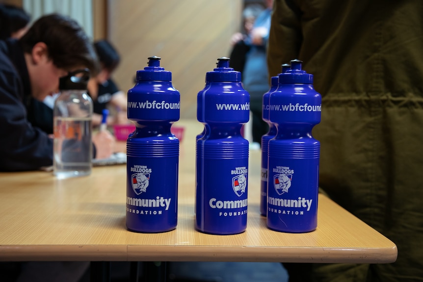 Three water bottles with Western Bulldogs branding.