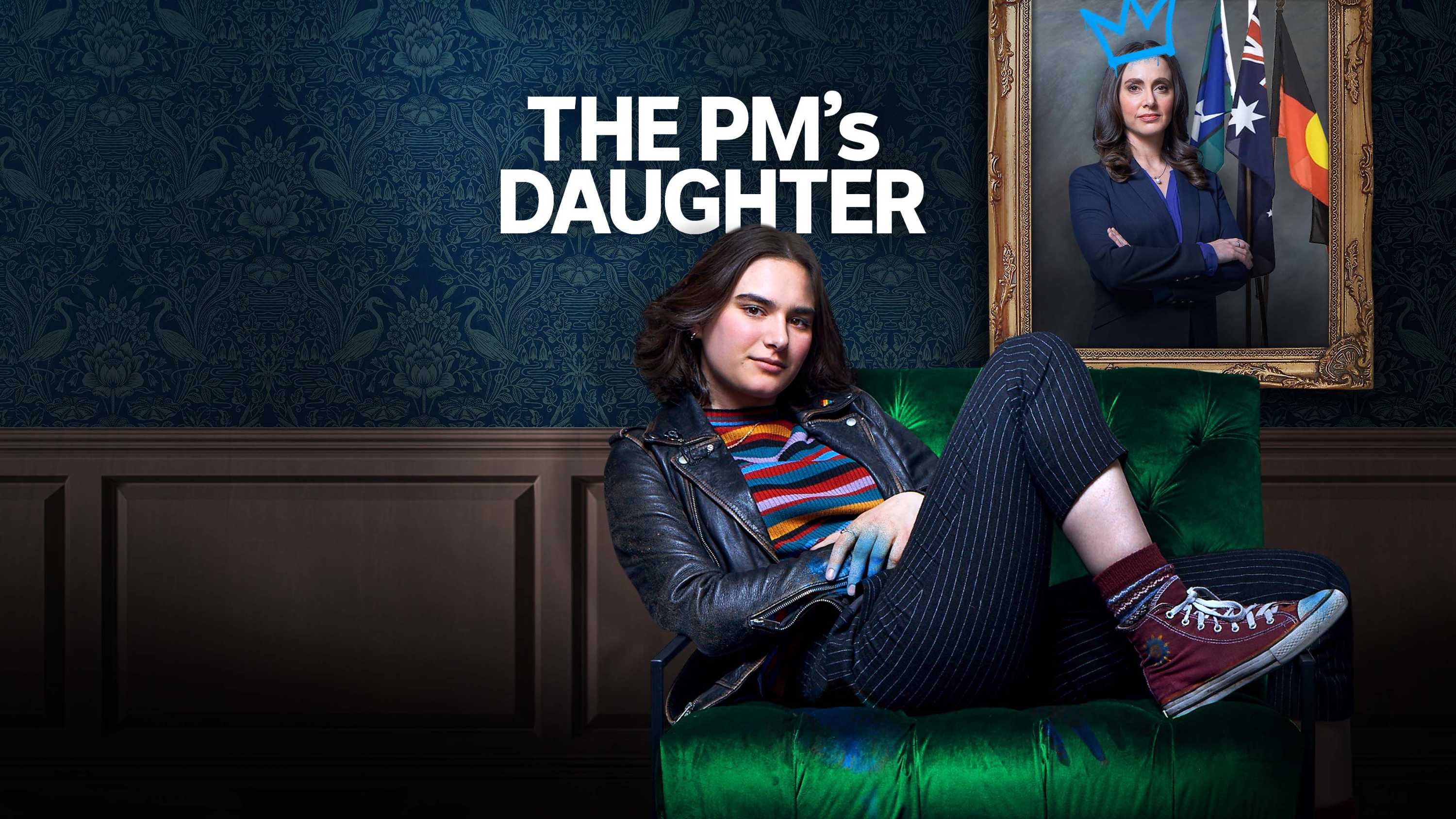 A teen reclines in a sofa seat with a graffitied painting of a lady on the wall