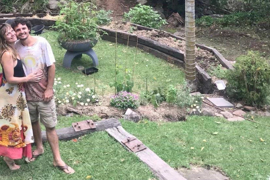 Leo Honek and his partner in Queensland next to their vegetable gardens