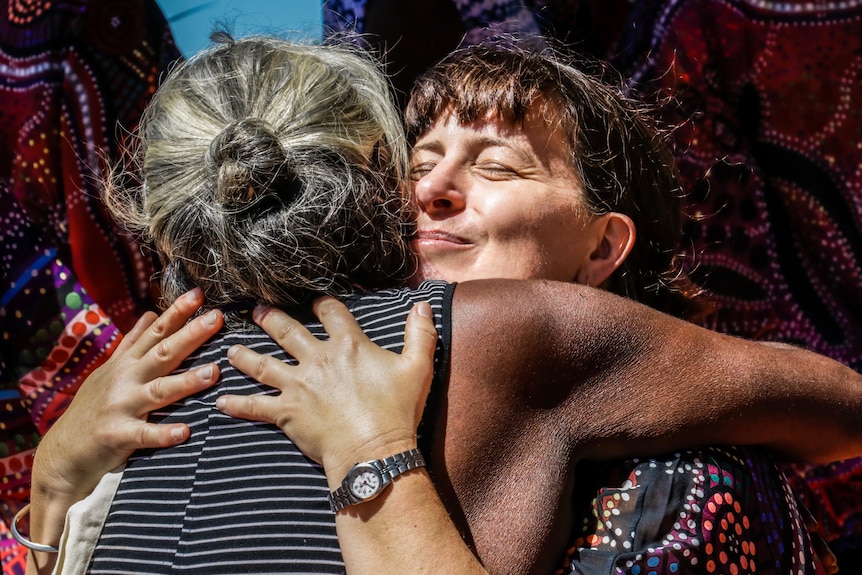 Dr Sarah Ireland hugs Glenda Goŋdjälk at the graduation ceremony.