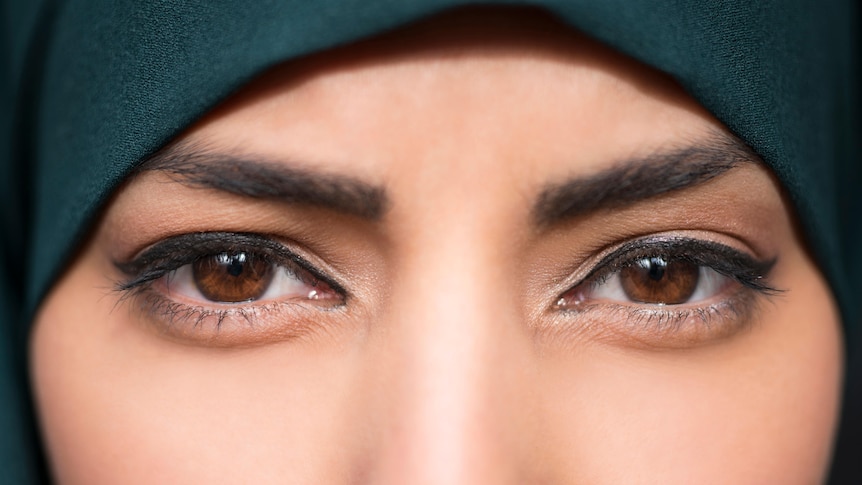 A woman wearing a hijab and wearing eyeliner