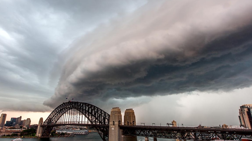A storm cloud moves across the Sydney Harbour Bridge.