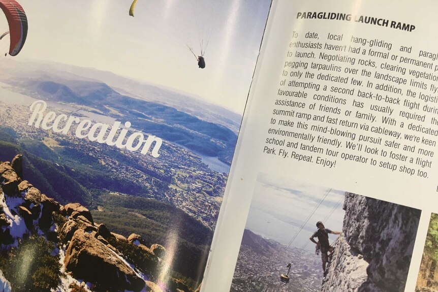 A photo of a glossy brochure featuring information on paragliding.