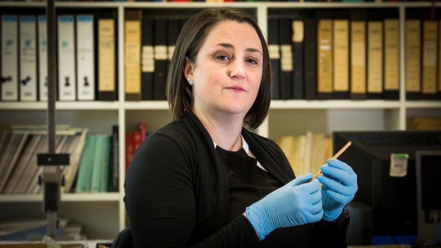 Michelle Langley holds Australia's oldest known bone tool.