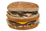 A hamburger with a sesame seed bun, two meat patties, pickles, cheese and white sauce