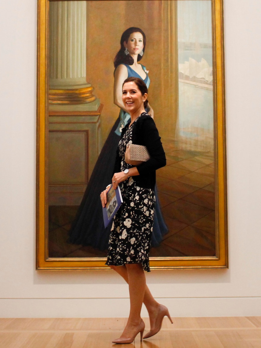 Princess Mary poses in front of portrait at the Portrait Gallery in Canberra.