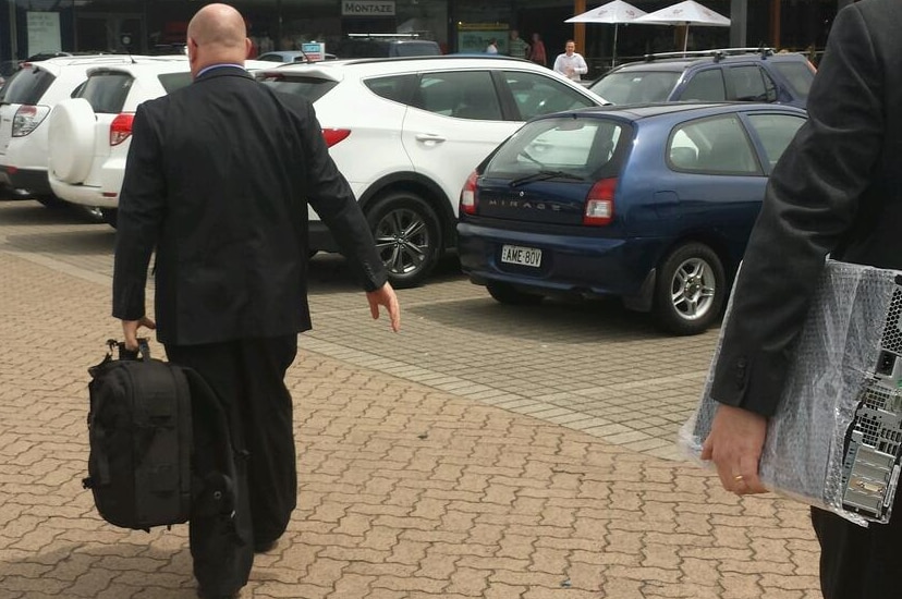 ICAC officials leave the office of former NSW energy minister Chris Hartcher.