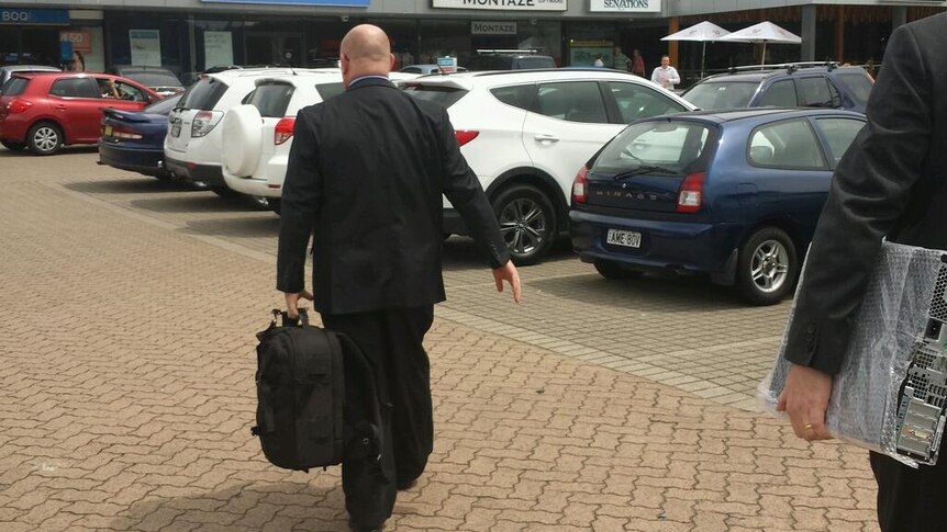 ICAC officials leave the office of former NSW energy minister Chris Hartcher.